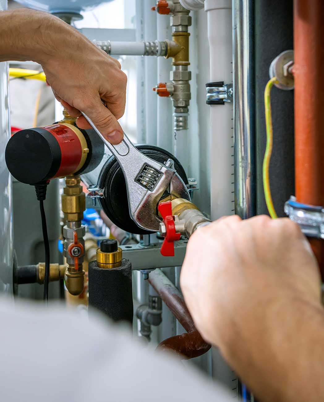 plumber working with wrench. screws the pipe fittings. banner co
